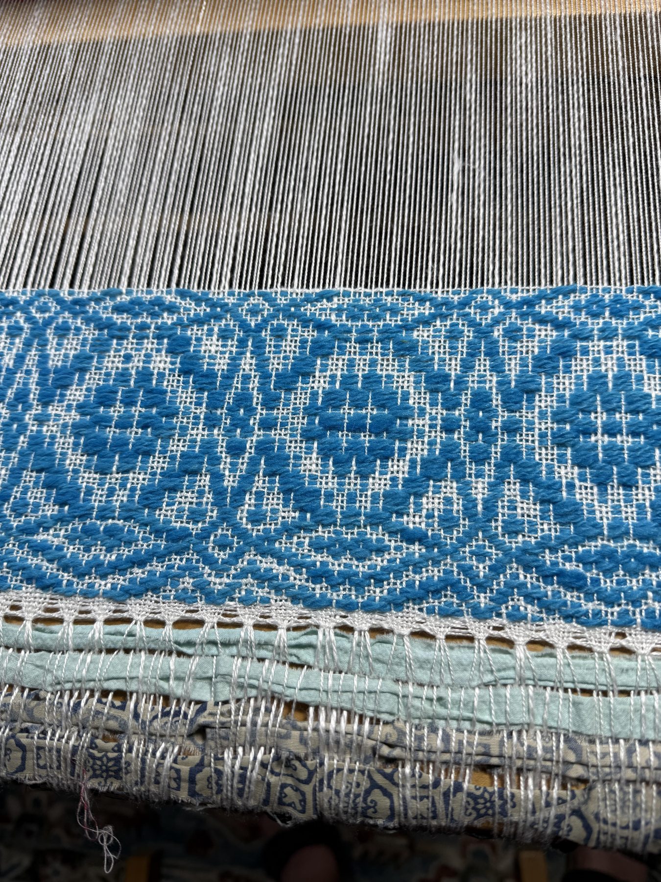 Close-up of blue diamond twill weaving on Carol's loom